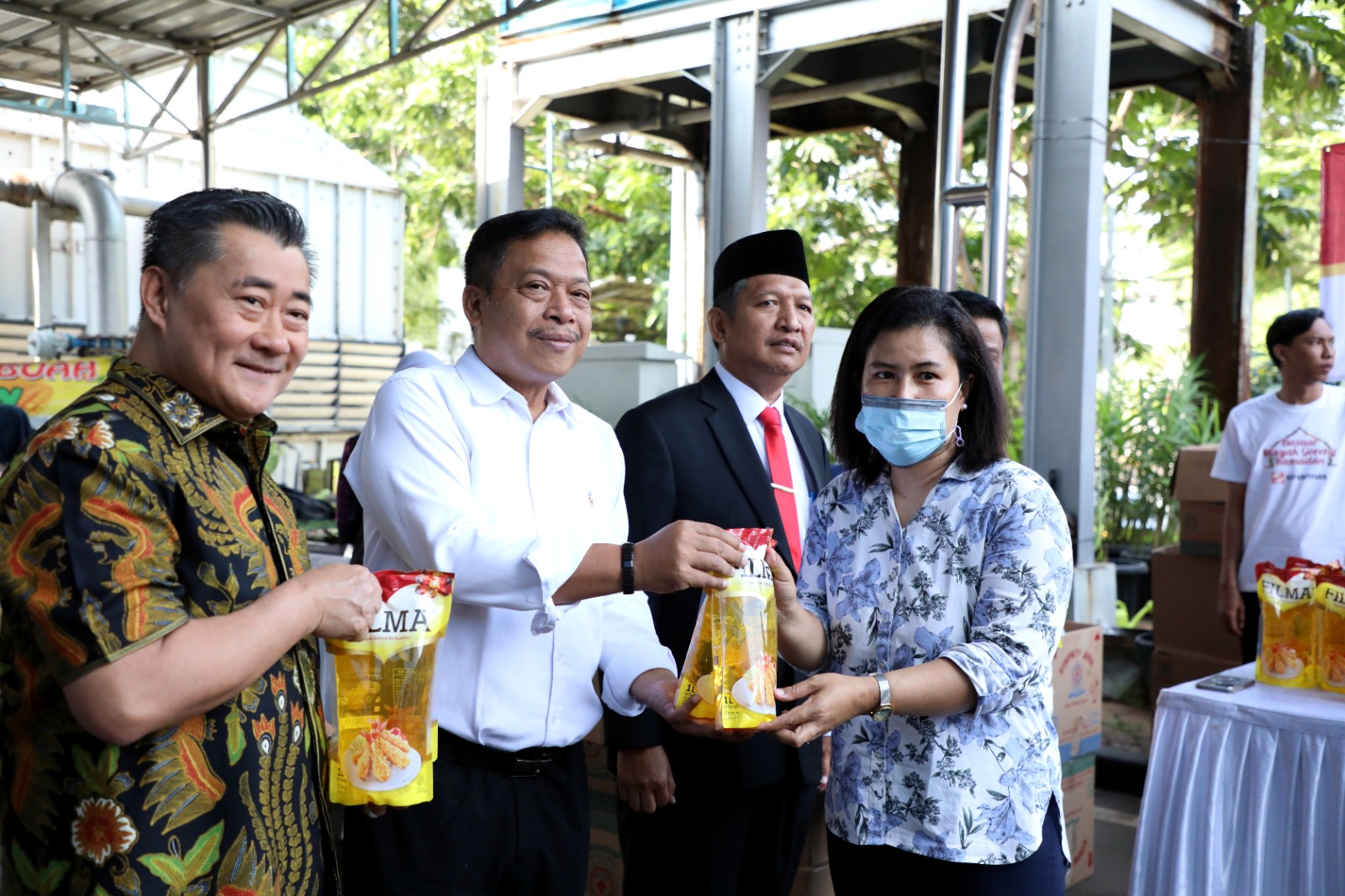 Direktur Kesiapsiagaan selaku Ketua Bidang Bazar Ramadan Pangarso Suryotomo (Dua kiri) menyerahkan minyak kepada salahsatu pembeli dalam acara bazar Ramadan yang digelar di Graha BNPB, Jakarta, Selasa (21/3). 